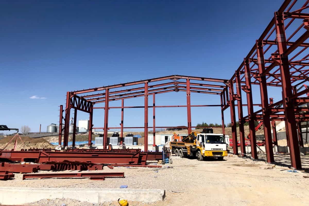 Maroon steel portal frames rising on the ASELSAN MGEO site