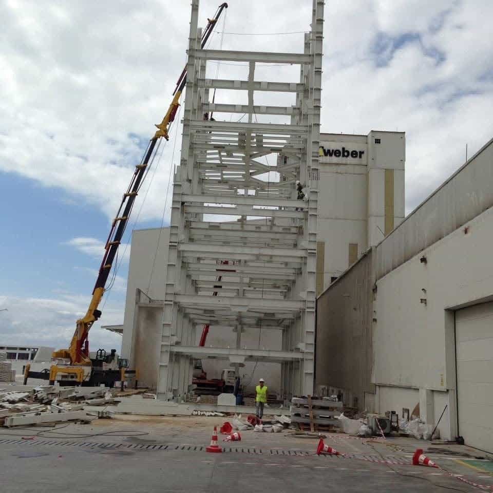 Steel silo support tower rising with a mobile crane at the Weber plant