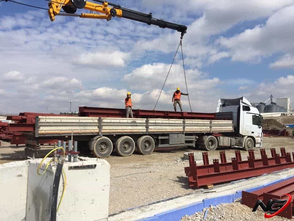 Steel members being lowered by crane at the Nuh Cement site