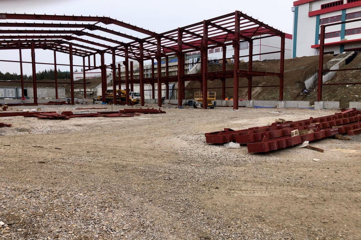 Steel roof trusses and members laid out on site