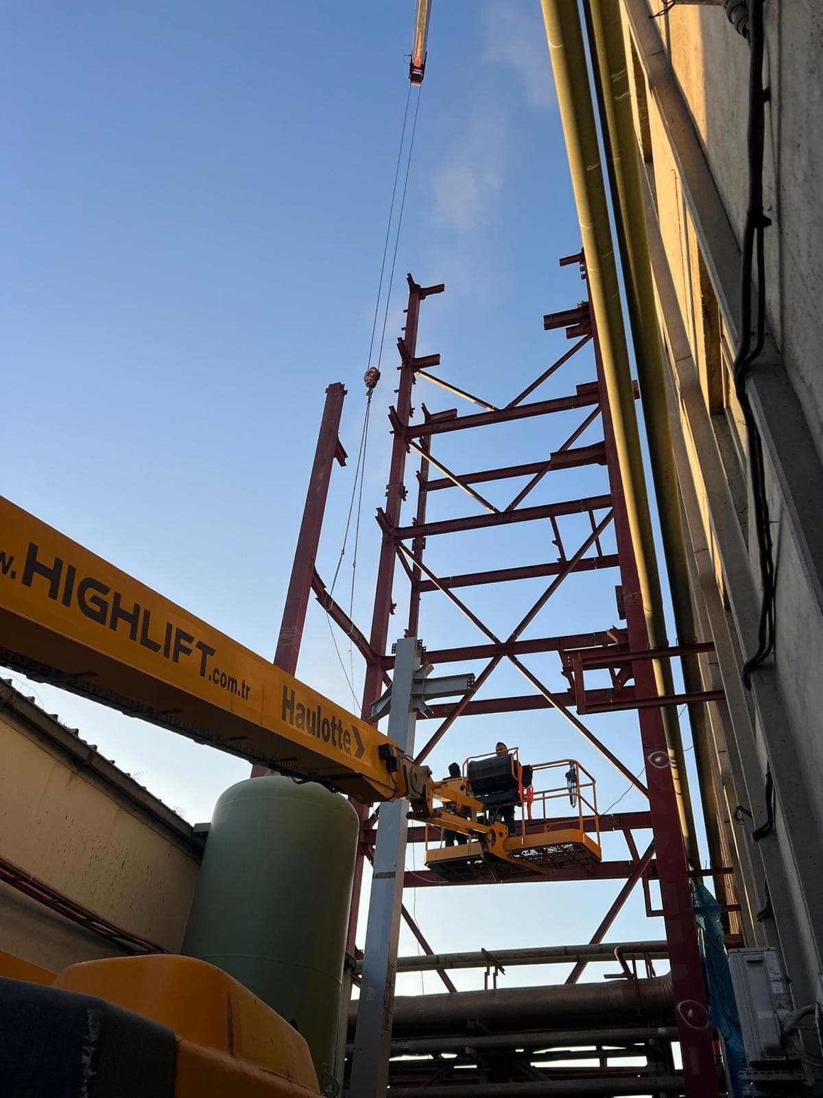 Erection work on a transfer tower using a boom lift