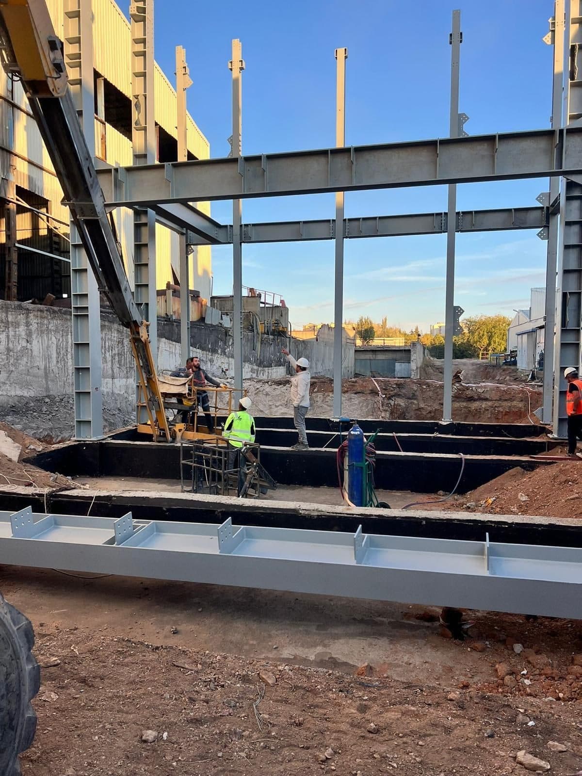 Building frame rising with steel columns and beams