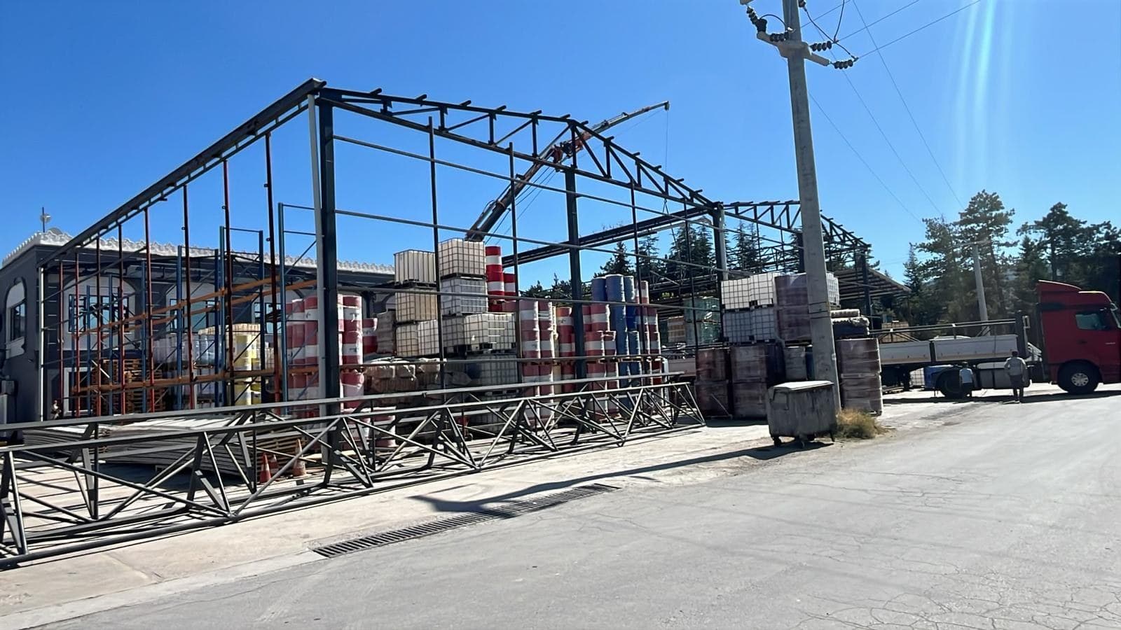 Steel roof trusses and columns rising at the Oksello oil plant