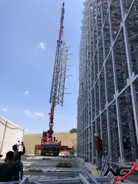 Racking frame being lifted by crane